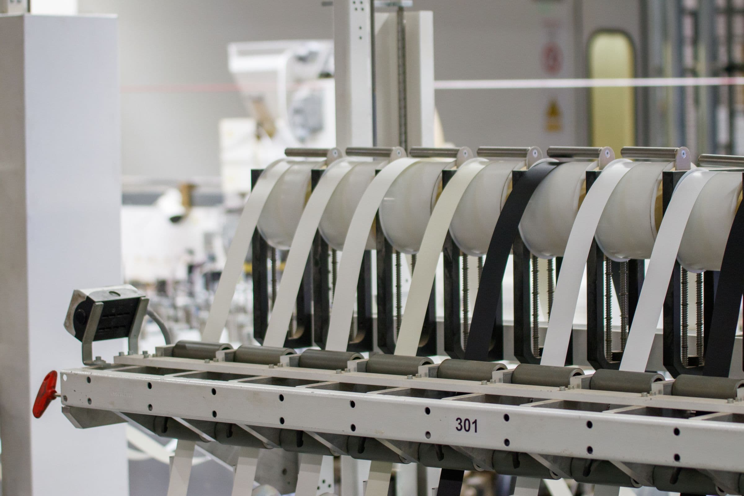 Rows of automated manufacturing equipment in a clean, modern industrial facility — general manufacturing context, not a depiction of Falcon's own test equipment