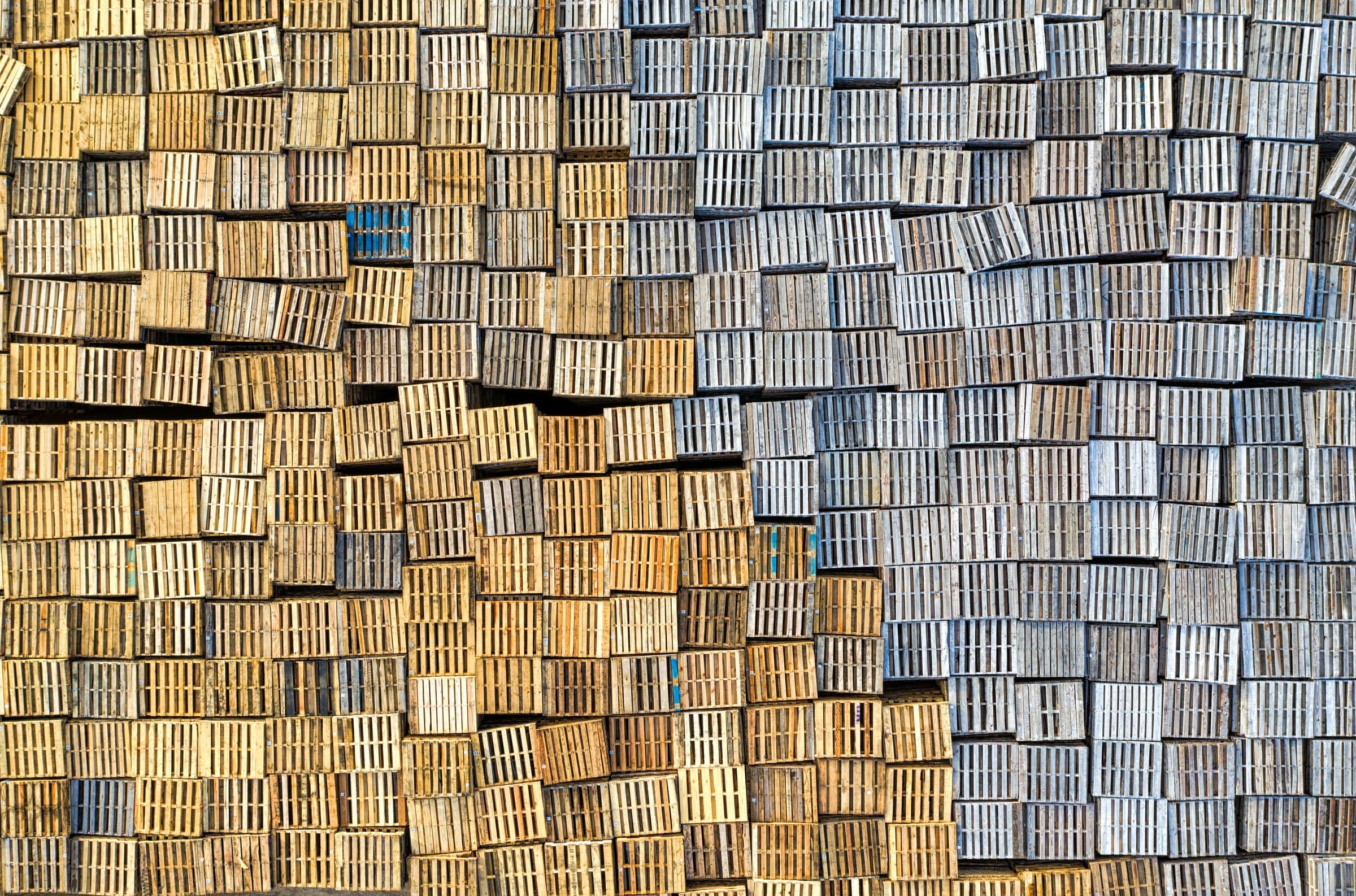 Aerial view of wooden pallets stacked in an outdoor storage yard