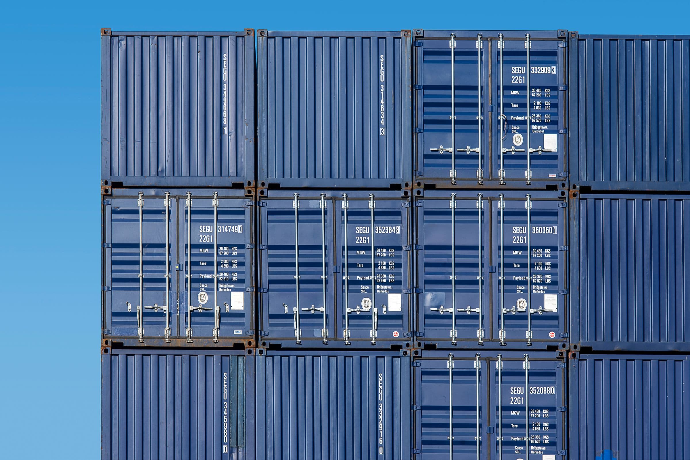 Stacked shipping containers representative of global transport and distribution